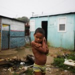 Santo Domingo, Rep. Domenicana. Un bimbo di fronte alla sua casa nel quartiere di La Cienaga Santo Domingo, Rep. Domenicana. Un bimbo di fronte alla sua casa nel quartiere di La Cienaga