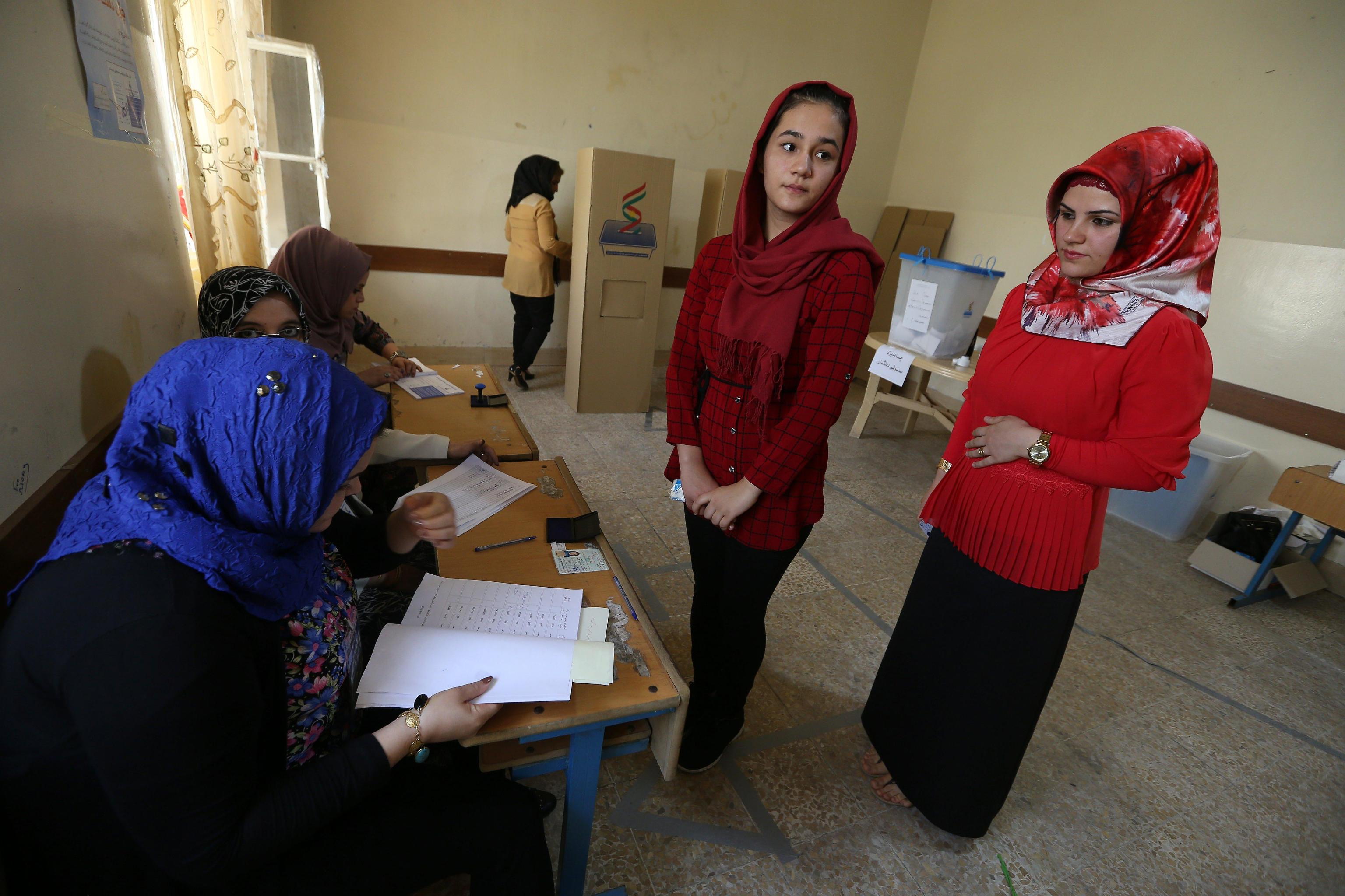 Registrazione e rilascio della scheda di voto in un seggio a Erbil