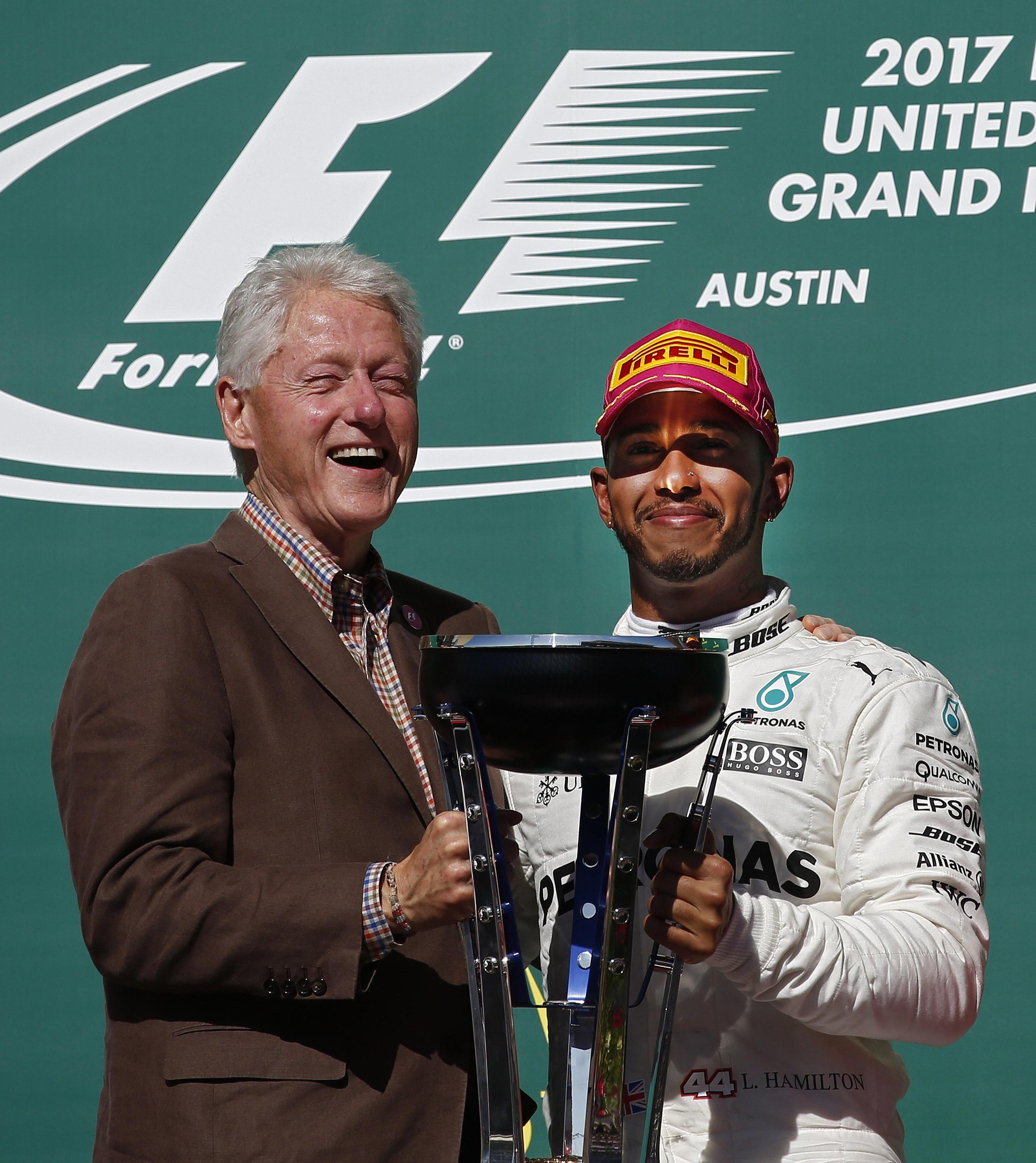 L'ex presidente degli Stati Uniti Bill Clinton consegna la coppa al vincitore del Gran Prix delle Americhe, il pilota Mercedes Lewis Hamilton
