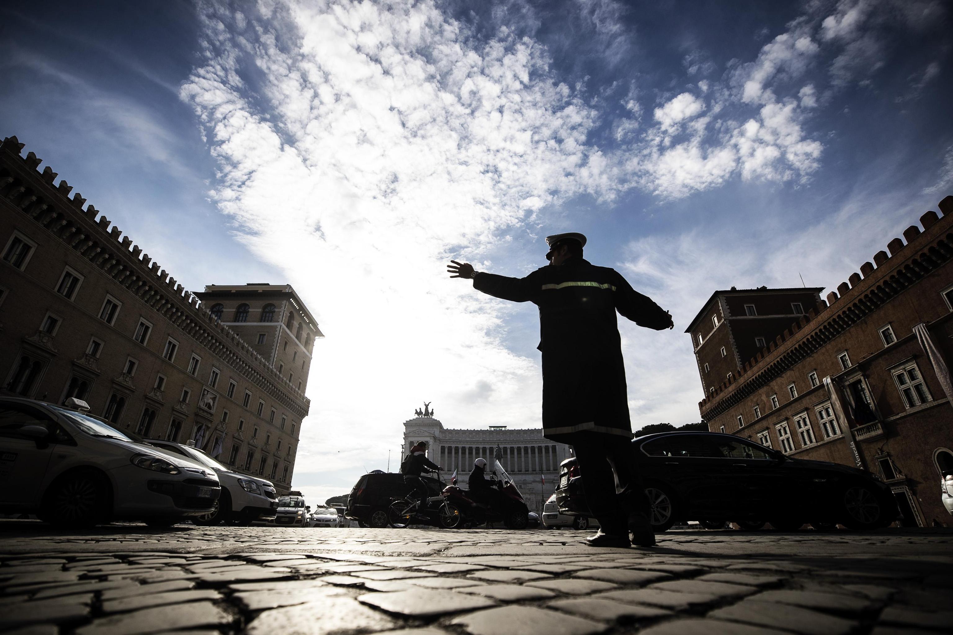 Un vigile dirige il traffico in Piazza Venezia a Roma