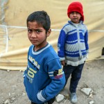 Bambini sfollati davanti a una tenda Bambini sfollati davanti a una tenda