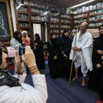 Un uomo ricorda il Mahatma Gandhi indossando gli stessi abiti