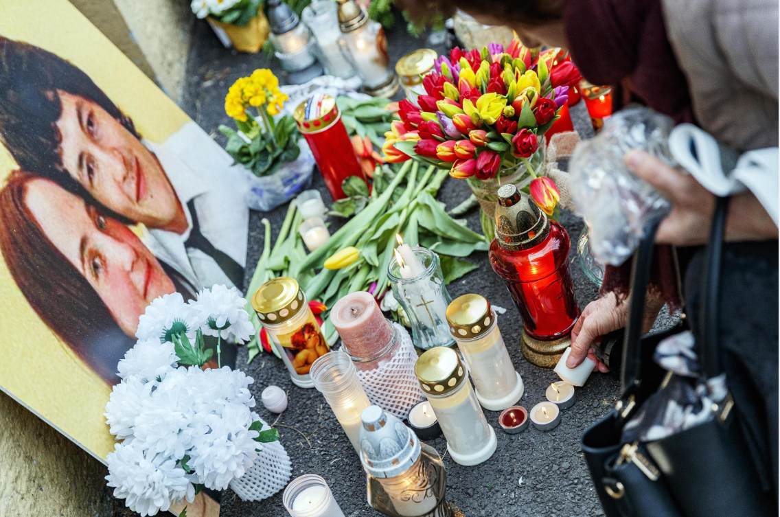 Alcuni manifestanti accendono candele accanto alla foto di Jan Kuciak Alcuni manifestanti accendono candele accanto alla foto di Jan Kuciak