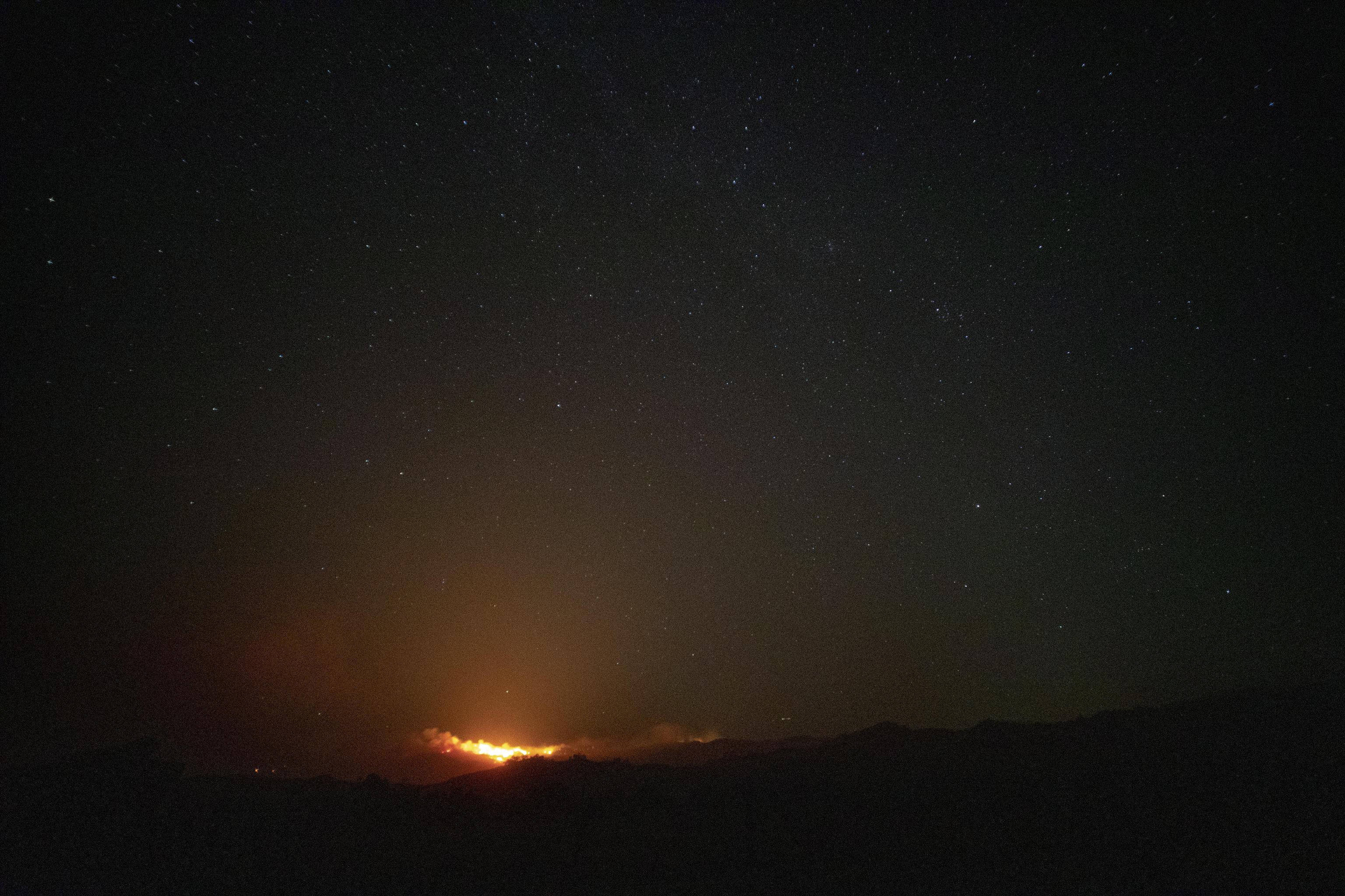 Le fiamme cominciano gradualmente a sormontare il cielo stellato della California