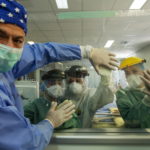 Gli infermieri toccano idealmente le mani dei medici dell'unità di terapia intensiva dell’ospedale Attikon ad Atene Gli infermieri toccano idealmente le mani dei medici dell'unità di terapia intensiva dell’ospedale Attikon ad Atene