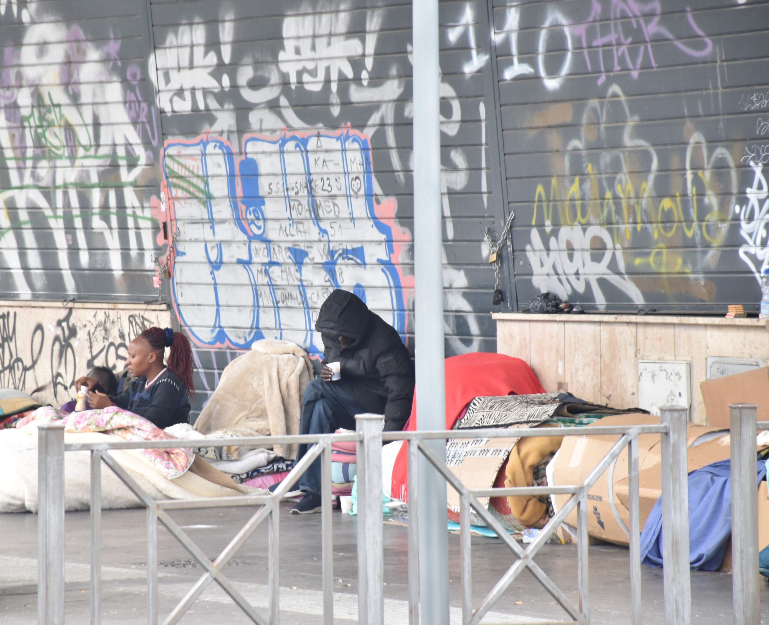 Alcuni senzatetto cercano di ripararsi dal freddo