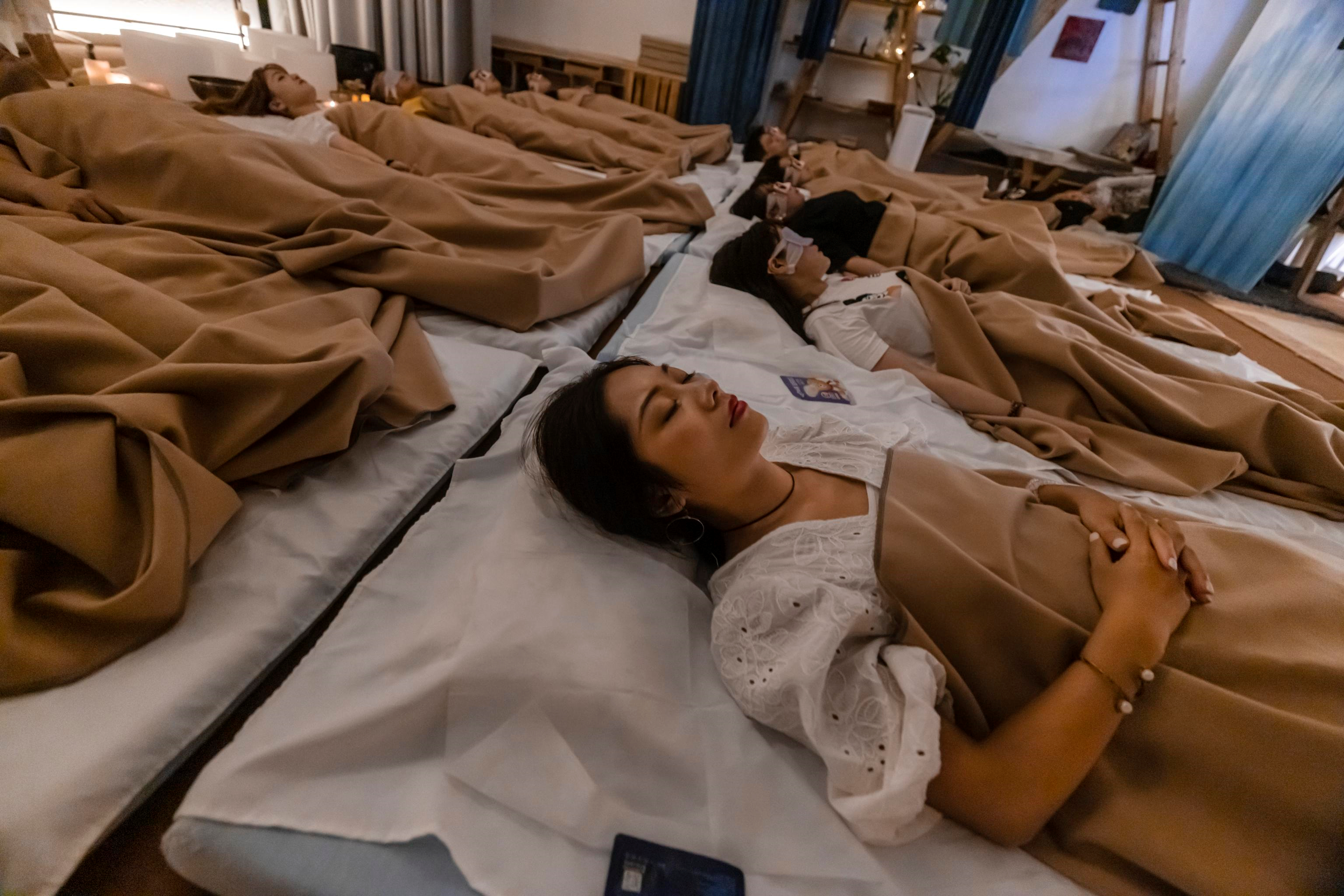Gruppo di clienti mentre dormono nella stanza della meditazione di Shanghai
