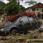 Un auto sommersa dai detriti trascinati dalla corrente