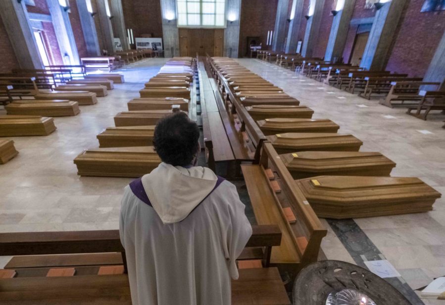 Un sacerdote benedice le bare nella parrocchia di San Giuseppe a Seriate, il 25 marzo 2020 Un sacerdote benedice le bare nella parrocchia di San Giuseppe a Seriate, il 25 marzo 2020