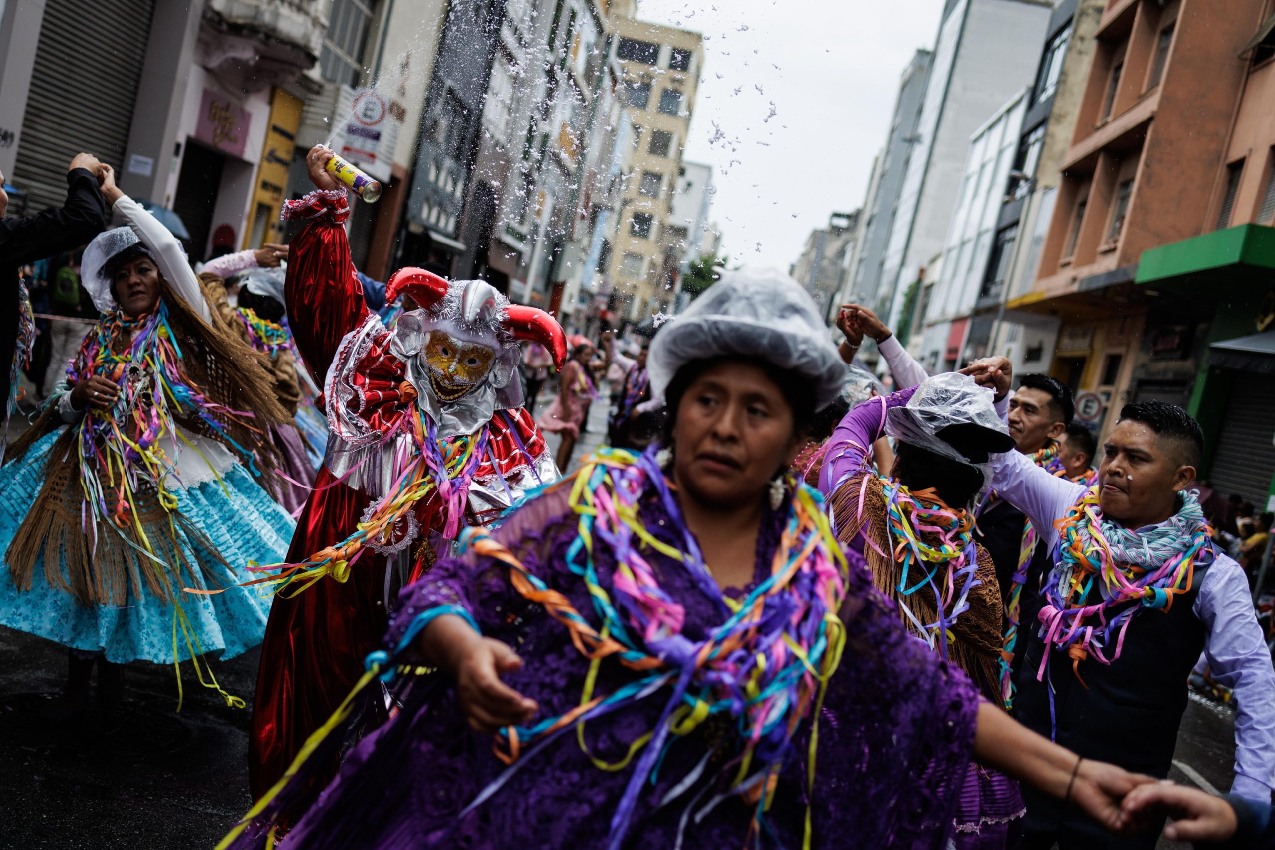 Per le strade di San Paolo in Brasile, schiuma e festoni si mischiano ad abiti a balli tradizionali boliviani