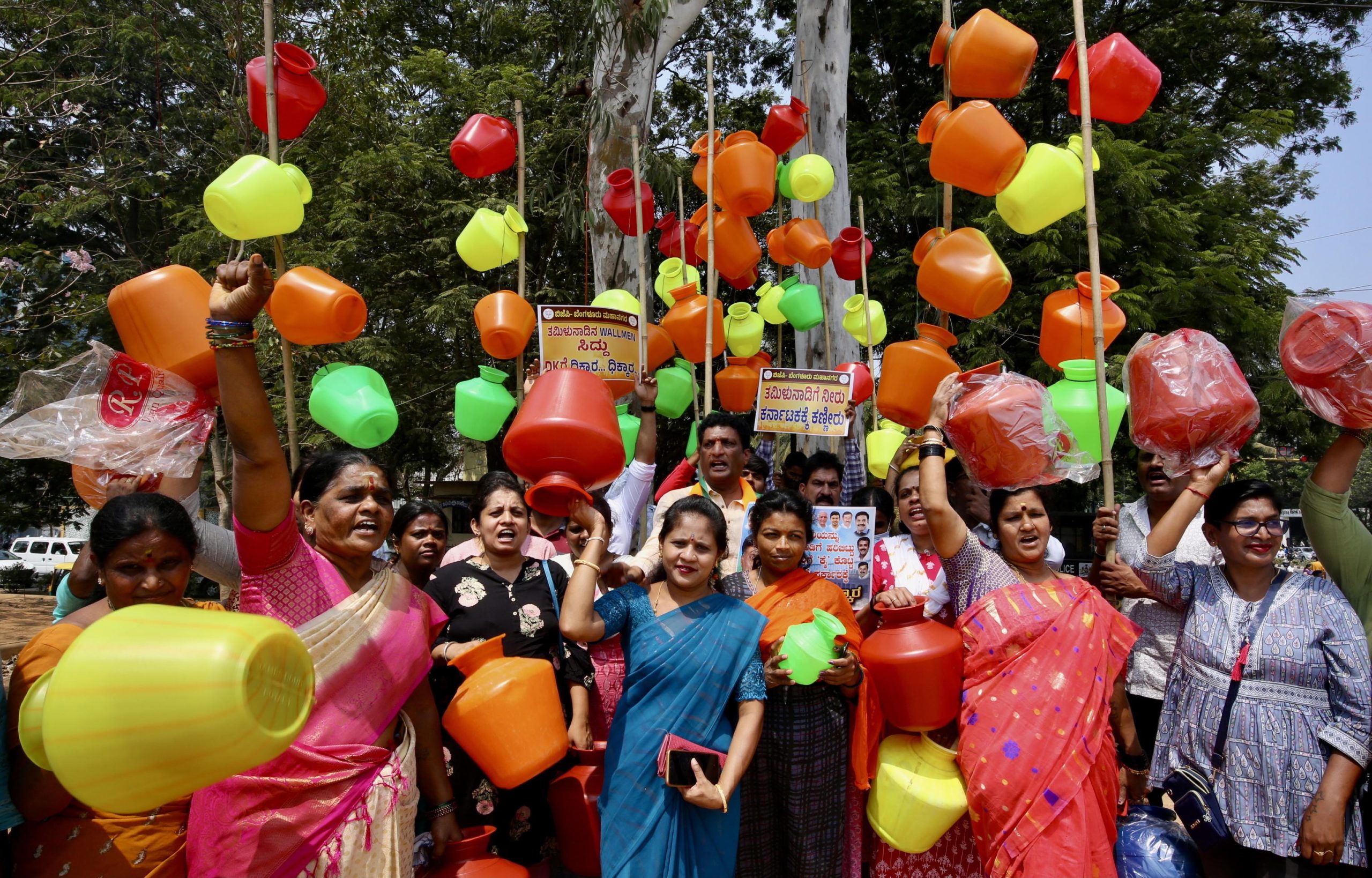 Le partecipanti mostrano in gruppo i vasi di plastica vuoti in segno di protesta Le partecipanti mostrano in gruppo i vasi di plastica vuoti in segno di protesta