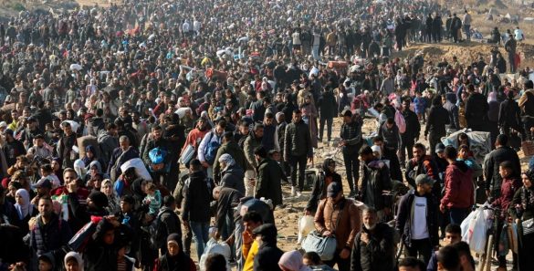 People walk along Gaza’s coastal al-Rashid Street to cross the Netzarim corridor from the southern Gaza Strip into the north on January 27, 2025.